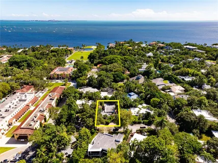 an aerial view of a large barn with lawn chairs