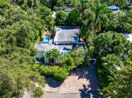 an aerial view of a house with a yard and garden