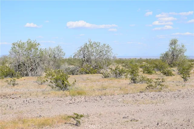 a view of ocean beach and mountain