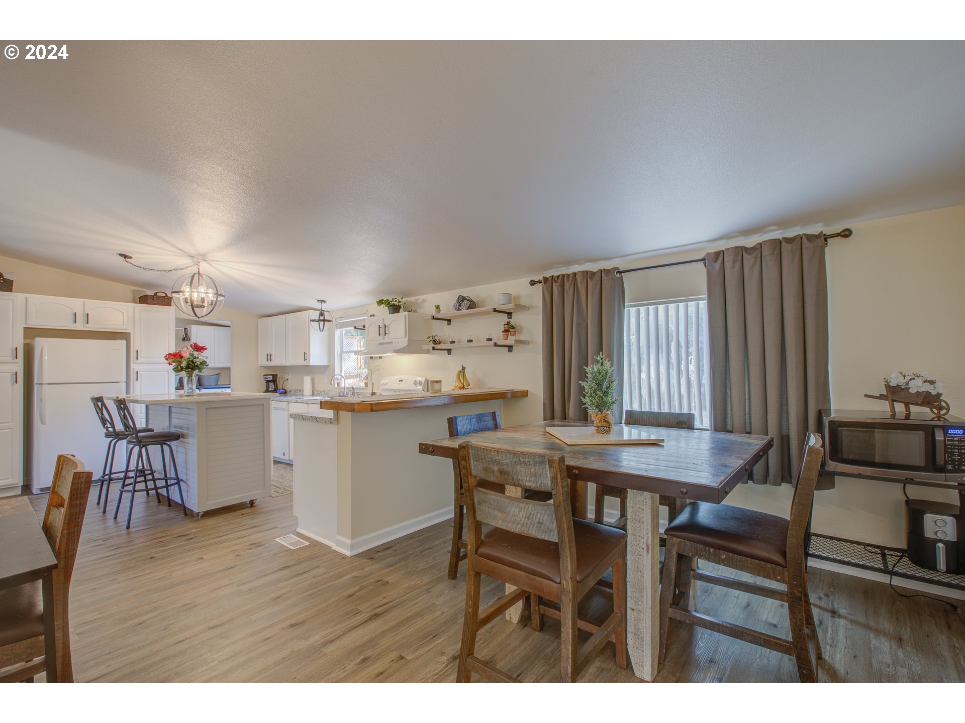 929 Northeast Rifle Range Street Roseburg, OR 97470 - Photo 14 of 48 a dining room with kitchen island a table and chairs