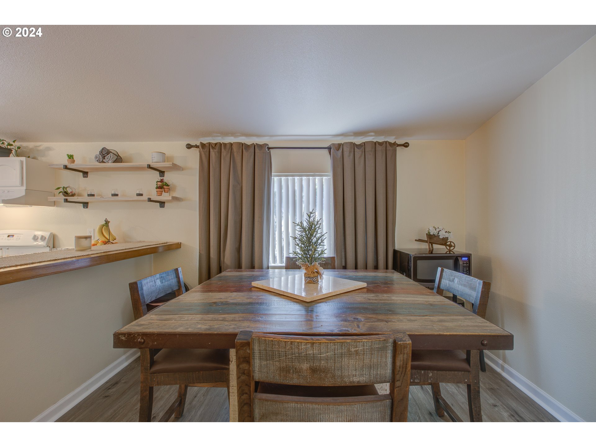 929 Northeast Rifle Range Street Roseburg, OR 97470 - Photo 15 of 48 a view of a dining room with furniture and wooden floor
