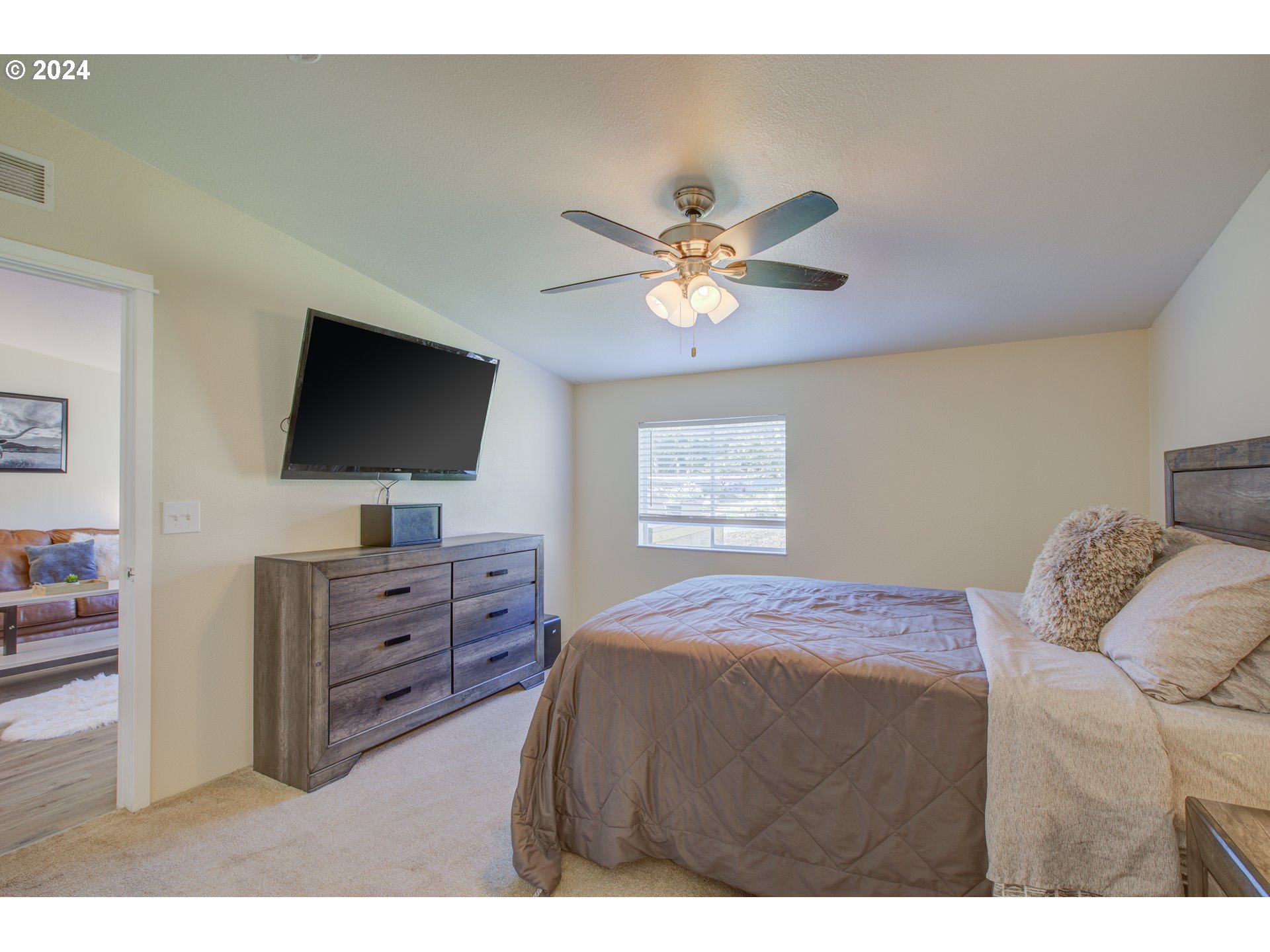 929 Northeast Rifle Range Street Roseburg, OR 97470 - Photo 18 of 48 a bedroom with a bed and a flat screen tv