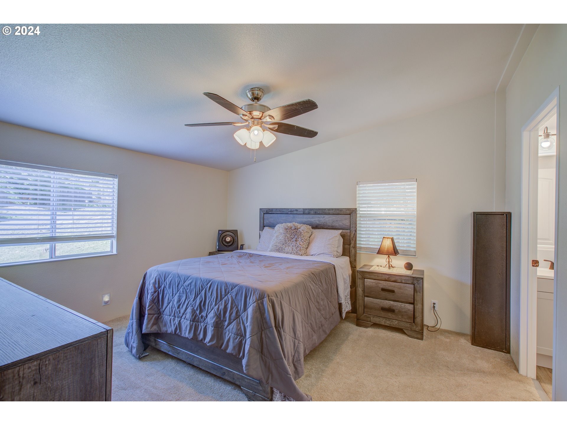 929 Northeast Rifle Range Street Roseburg, OR 97470 - Photo 19 of 48 a bedroom with a bed and a chandelier