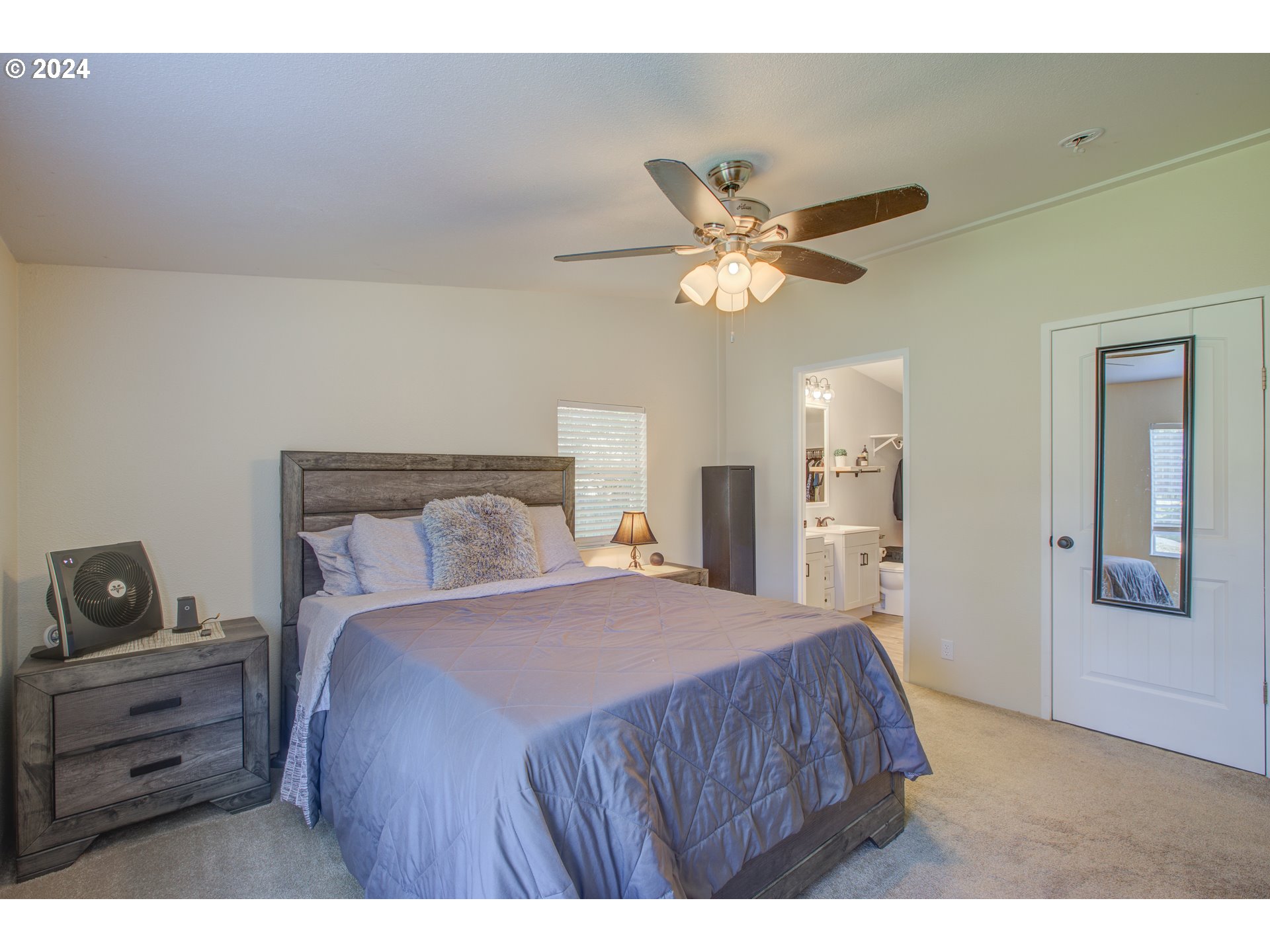 929 Northeast Rifle Range Street Roseburg, OR 97470 - Photo 20 of 48 a bedroom with a bed and a chandelier