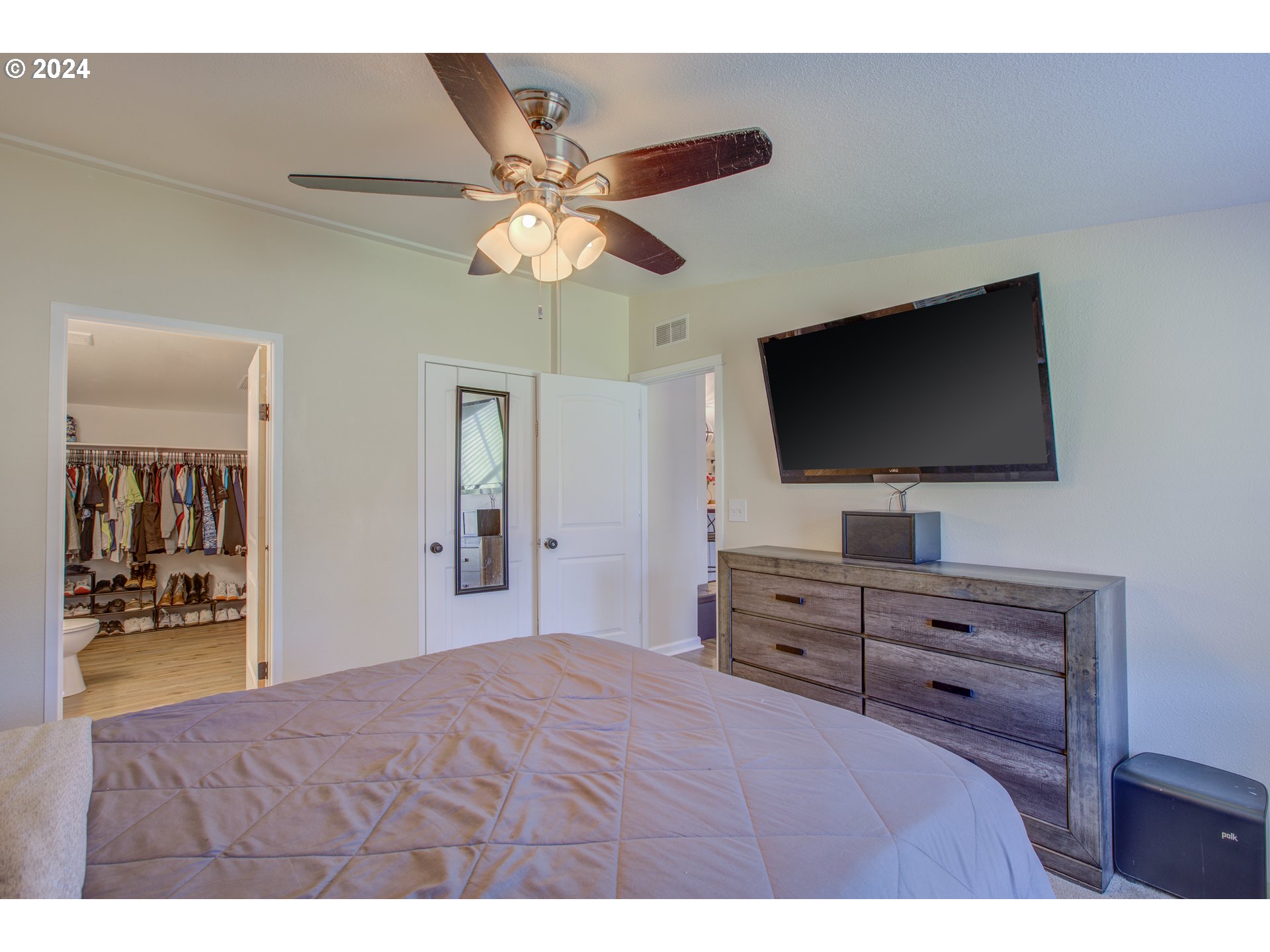 929 Northeast Rifle Range Street Roseburg, OR 97470 - Photo 21 of 48 a bedroom with a bed and a flat screen tv