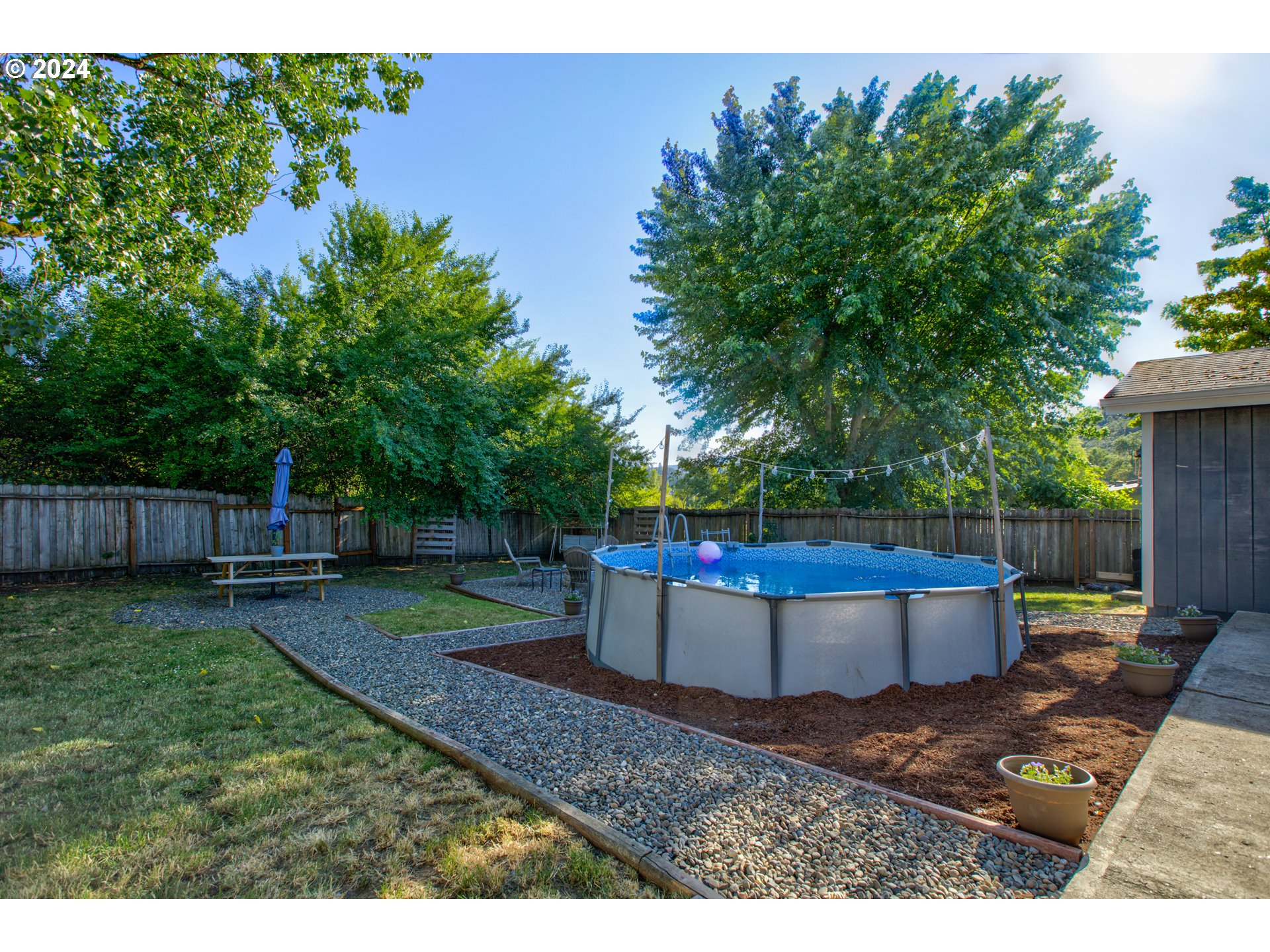 929 Northeast Rifle Range Street Roseburg, OR 97470 - Photo 42 of 48 a backyard of a house with lots of green space