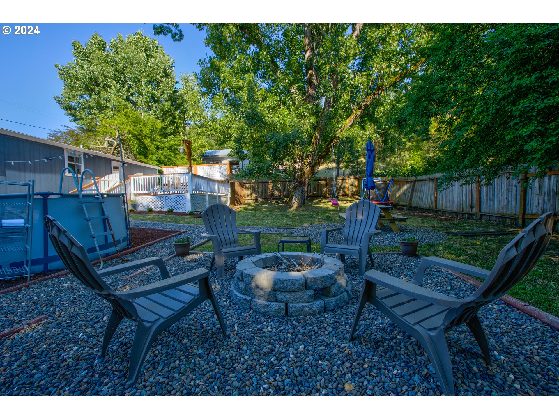 929 Northeast Rifle Range Street Roseburg, OR 97470 - Photo 45 of 48 a backyard of a house with table and chairs