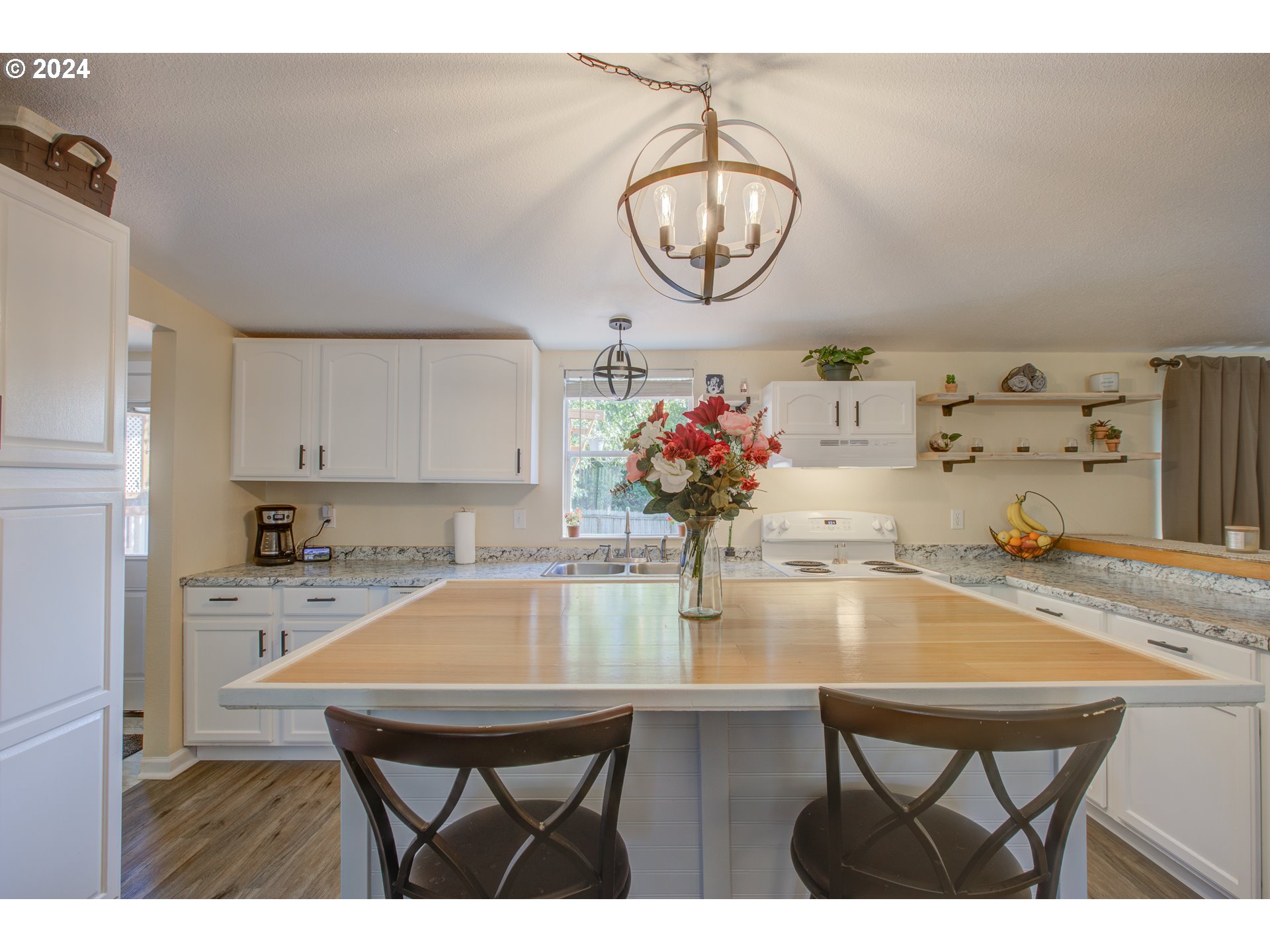 929 Northeast Rifle Range Street Roseburg, OR 97470 - Photo 8 of 48 a kitchen with a table and chandelier
