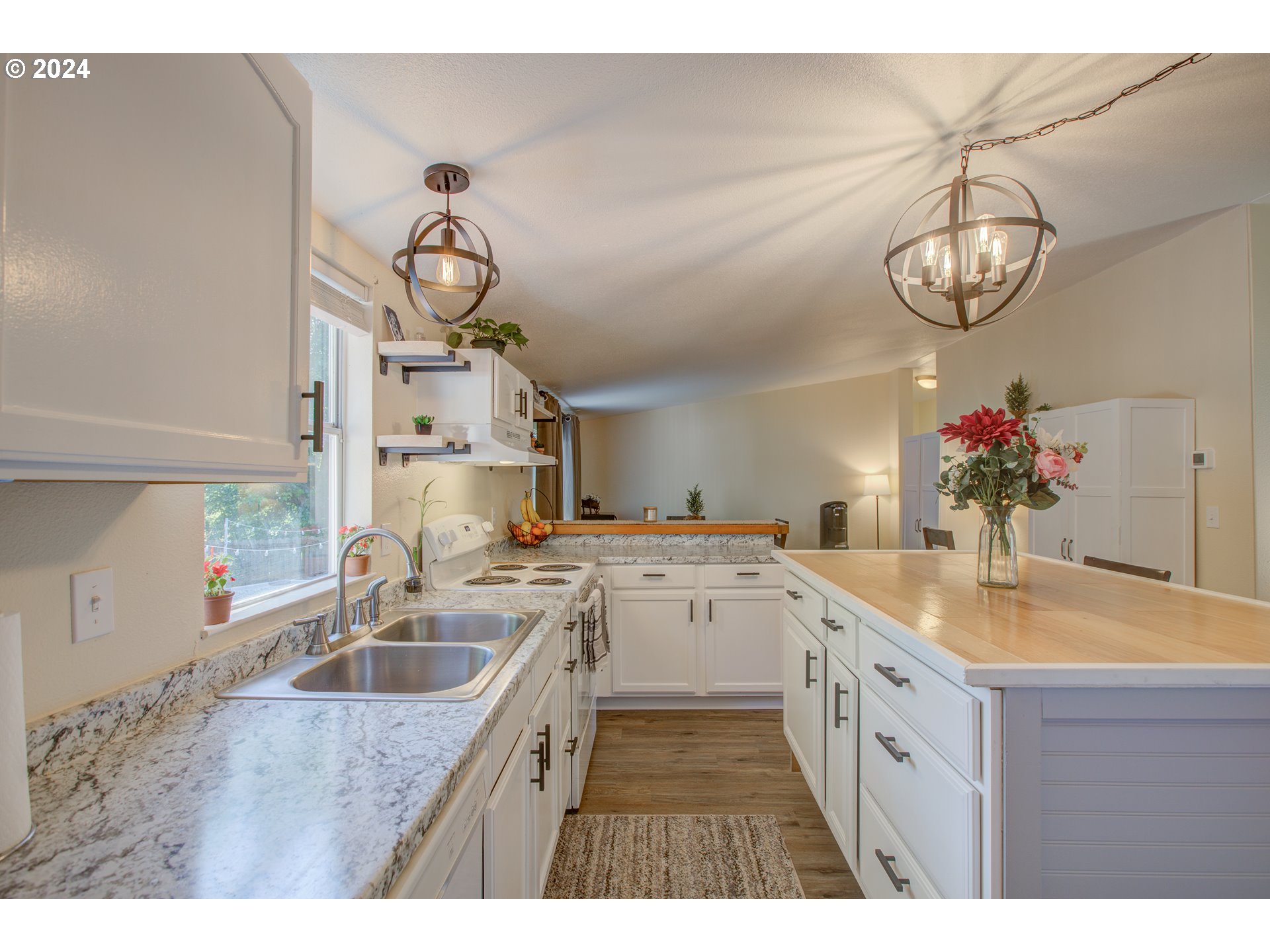929 Northeast Rifle Range Street Roseburg, OR 97470 - Photo 9 of 48 a kitchen with a sink dishwasher and a stove with wooden floor