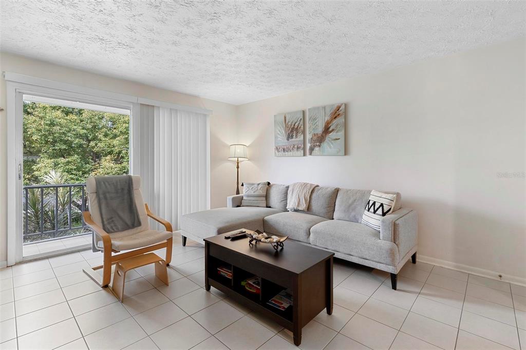 4376 Lake Underhill Road, Unit C Orlando, FL 32803 - Photo 11 of 41 a living room with furniture and a floor to ceiling window