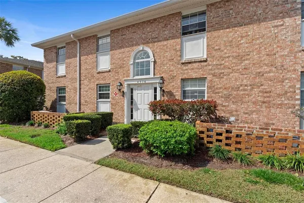 a view of a brick house with a yard