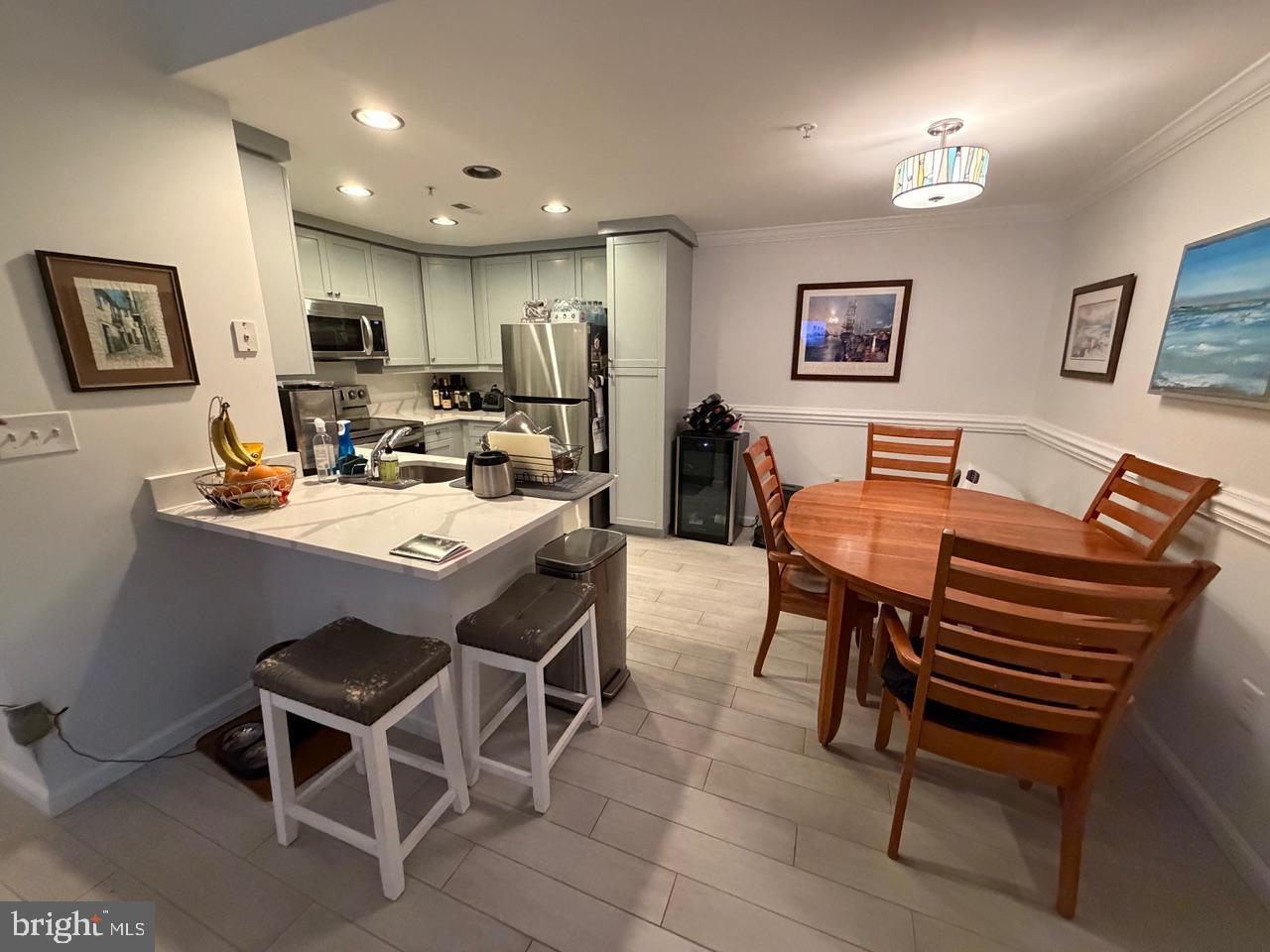 1111 11th Street Northwest, Unit 108 Washington, DC 20001 - Photo 12 of 27 Modern kitchen and dining area blend.