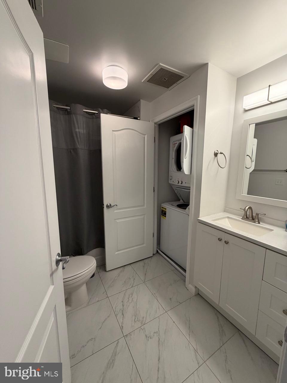 1111 11th Street Northwest, Unit 108 Washington, DC 20001 - Photo 21 of 27 Modern bathroom with laundry convenience.