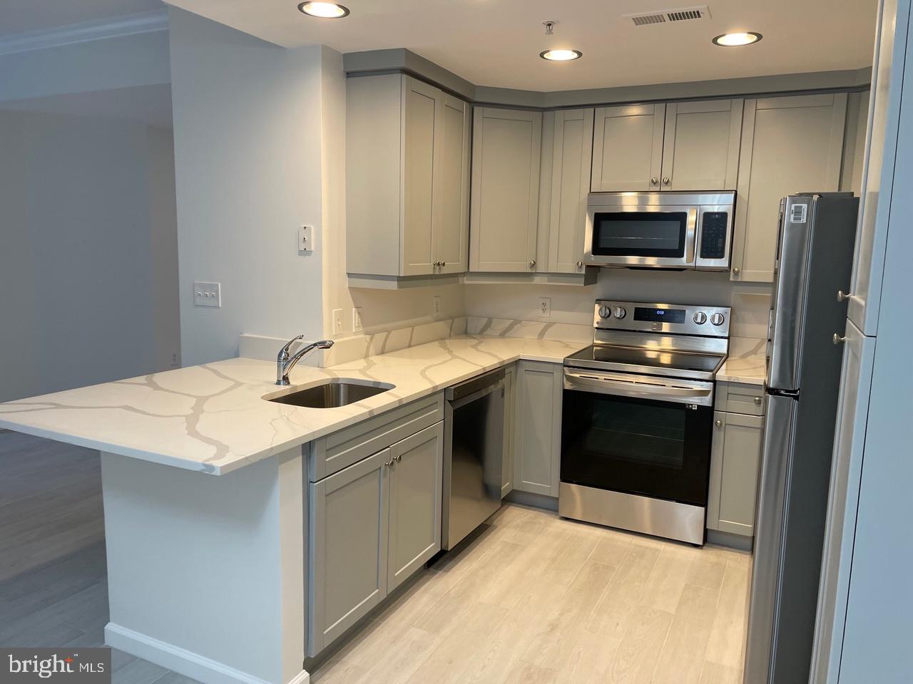 1111 11th Street Northwest, Unit 108 Washington, DC 20001 - Photo 9 of 27 Kitchen w/ SS Appliances and Granite Countertops