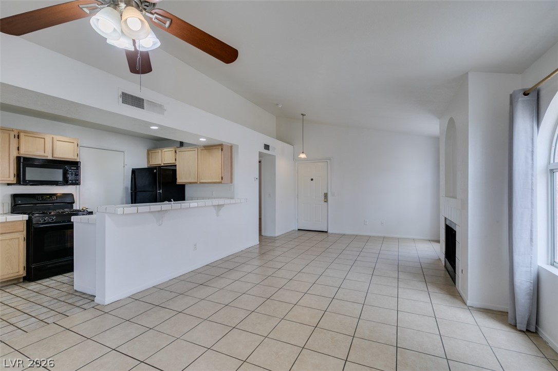 7570 West Flamingo Road, Unit 252 Las Vegas, NV 89147 - Photo 18 of 44 An open-concept living space integrates a functional kitchen with a bright, vaulted-ceiling great room.