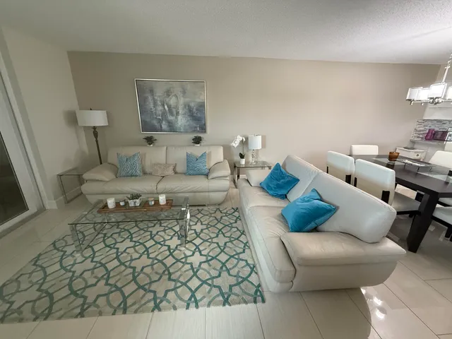 a living room with furniture and a rug