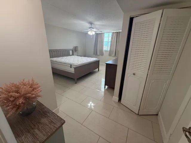 a bedroom with a sink and a mirror