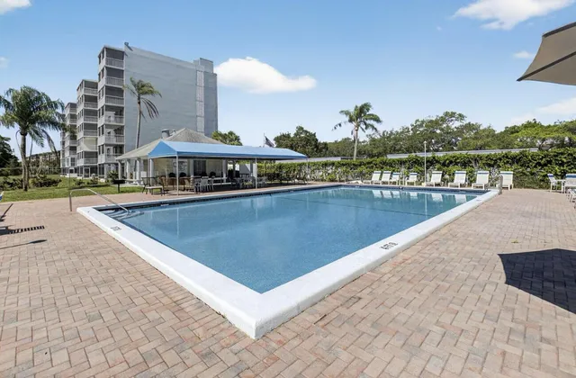 a view of a swimming pool with a lounge chair