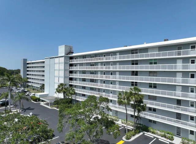 a front view of a building with outdoor space and street view