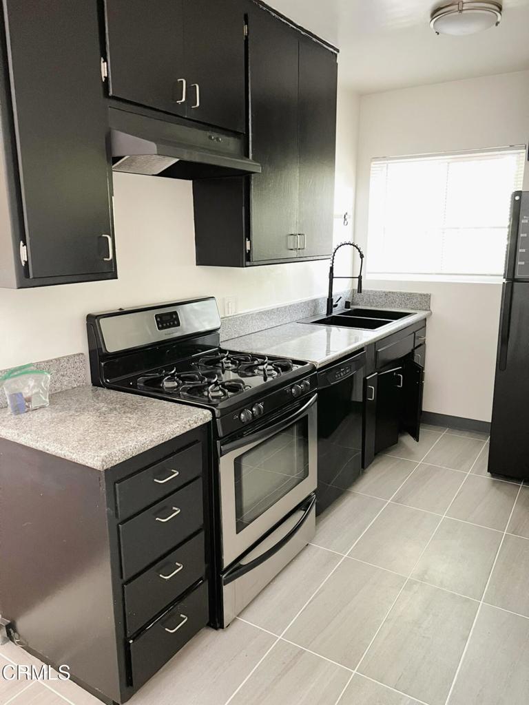 12256 Riverside Drive, Unit 2 Valley Village, CA 91607 - Photo 3 of 7 a kitchen with stainless steel appliances granite countertop a sink and a stove