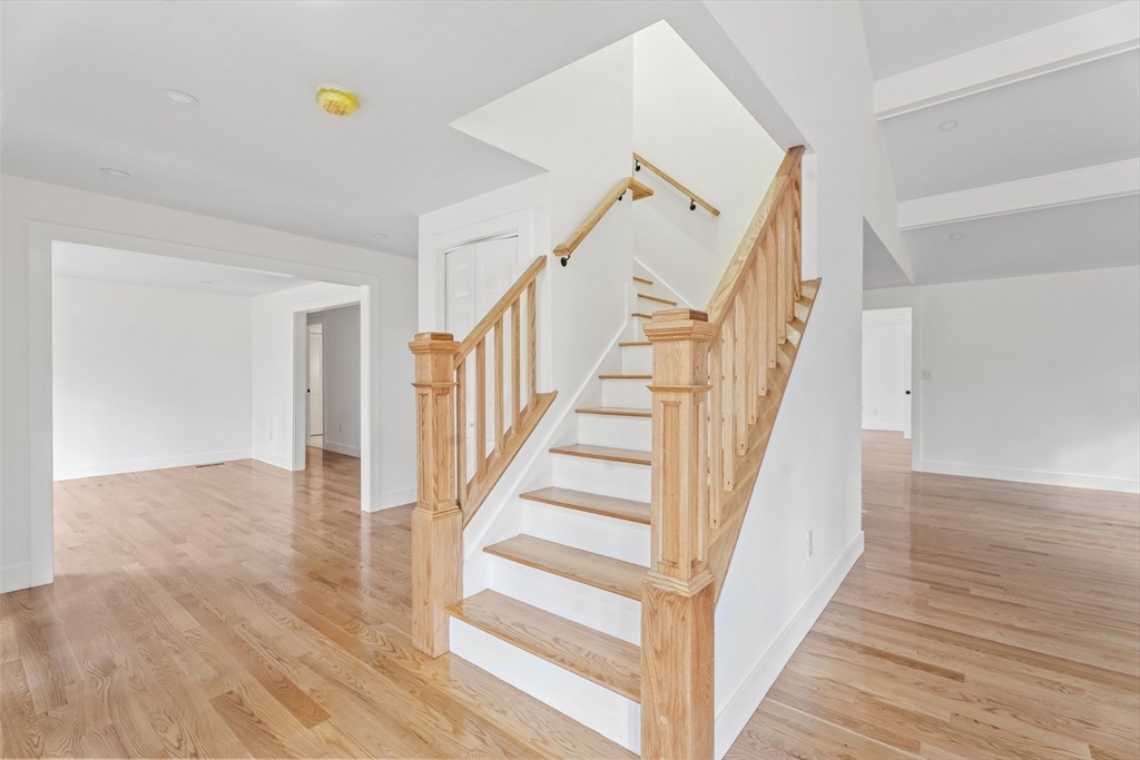 32 Laurel Lane Raynham, MA 02767 - Photo 12 of 30 a view of a hallway with wooden floor and staircase