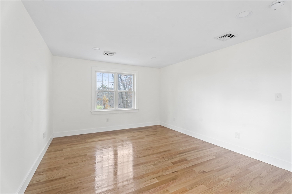 32 Laurel Lane Raynham, MA 02767 - Photo 16 of 30 a view of empty room with wooden floor and fan