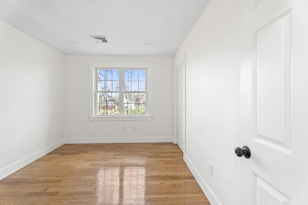 32 Laurel Lane Raynham, MA 02767 - Photo 17 of 30 a view of an empty room with wooden floor and a window