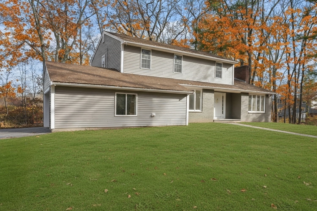32 Laurel Lane Raynham, MA 02767 - Photo 2 of 30 a front view of a house with a garden