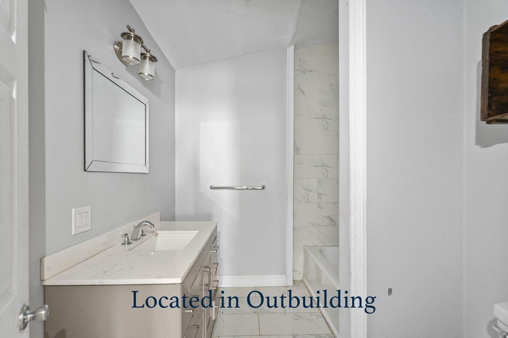 32 Laurel Lane Raynham, MA 02767 - Photo 30 of 30 a bathroom with a sink and a mirror