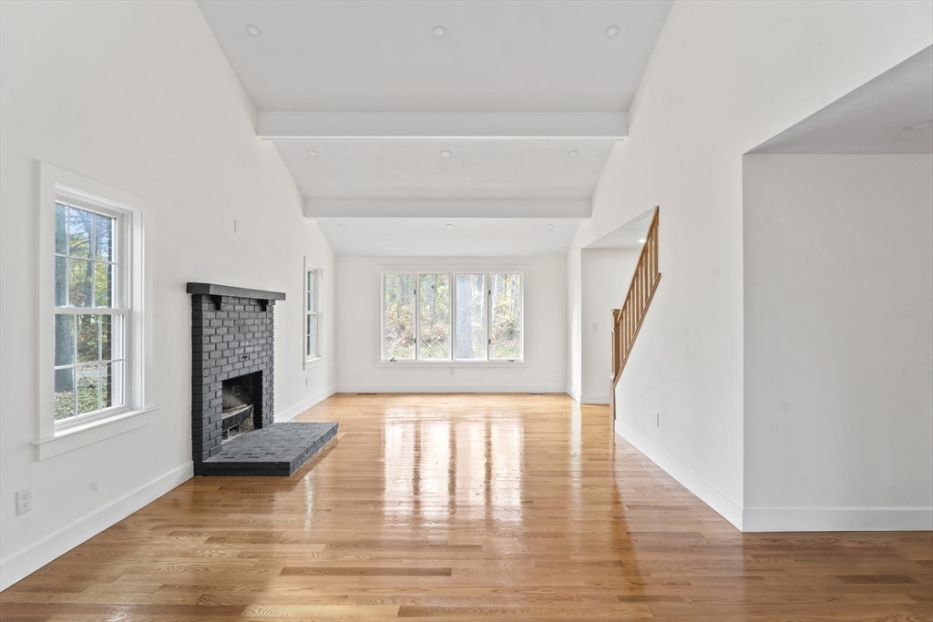 32 Laurel Lane Raynham, MA 02767 - Photo 4 of 30 a view of an empty room with wooden floor fireplace and a window