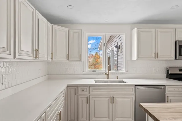 a kitchen with a sink cabinets and window