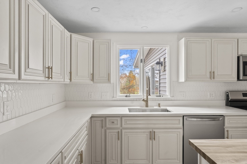 32 Laurel Lane Raynham, MA 02767 - Photo 7 of 30 a kitchen with a sink cabinets and window