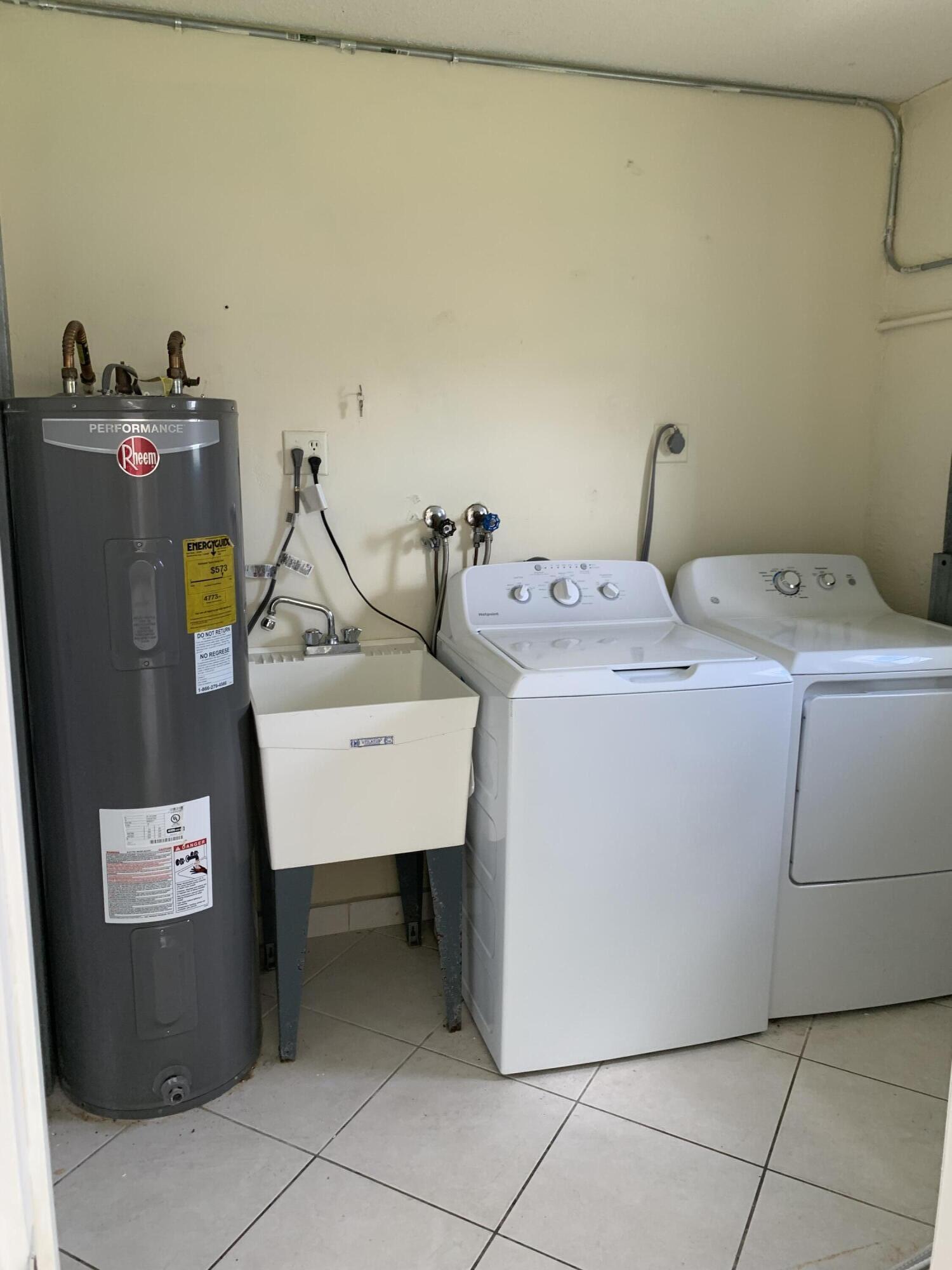 2802 Regency Court Delray Beach, FL 33445 - Photo 5 of 10 a utility room with dryer and washer