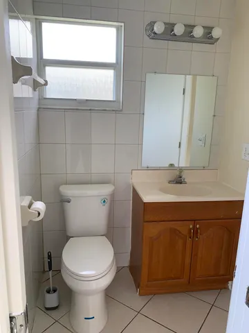 a bathroom with a sink a toilet and mirror