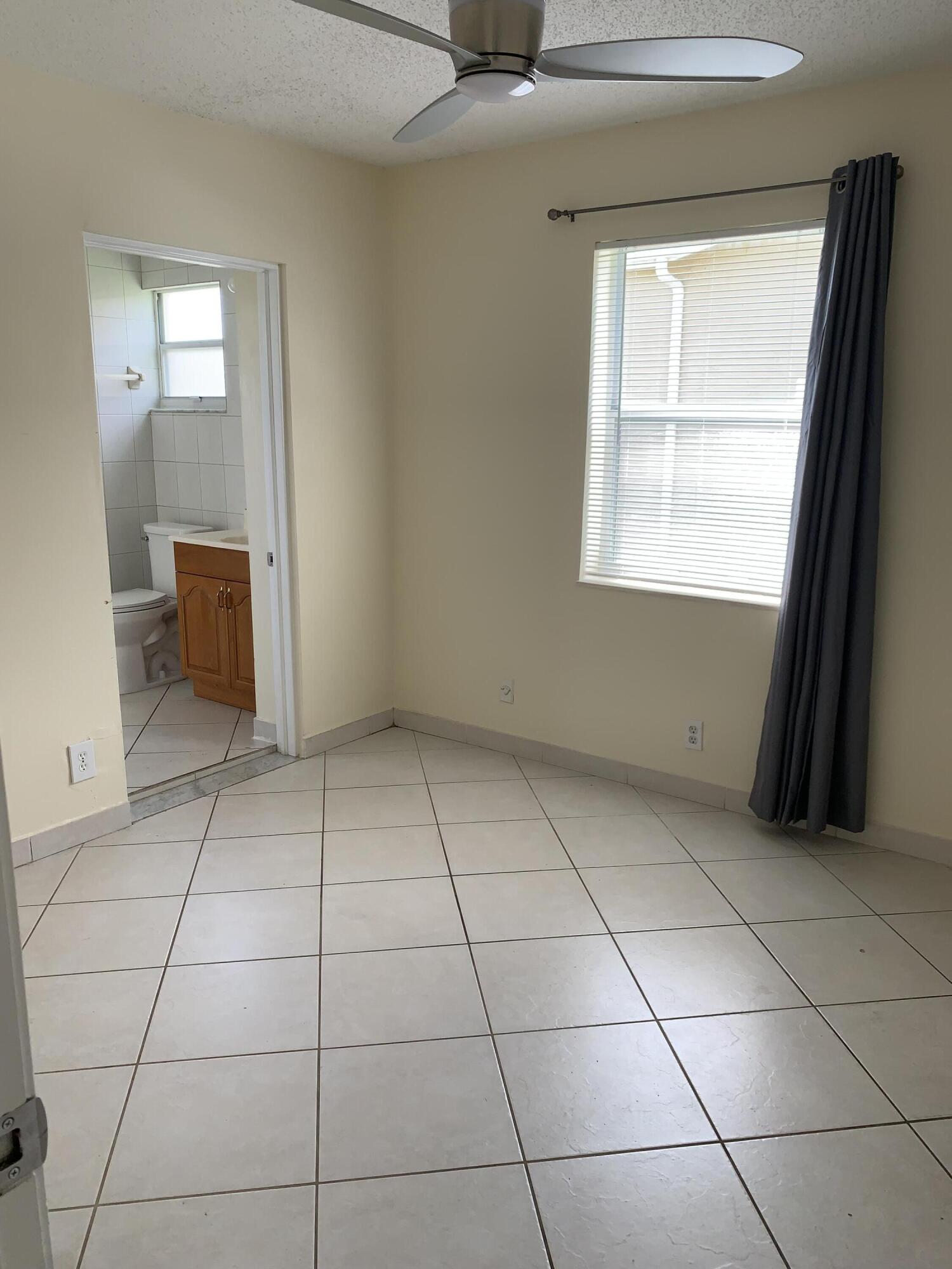 2802 Regency Court Delray Beach, FL 33445 - Photo 8 of 10 a view of an empty room with a window
