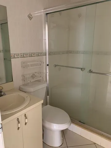 a white toilet sitting next to a bath tub