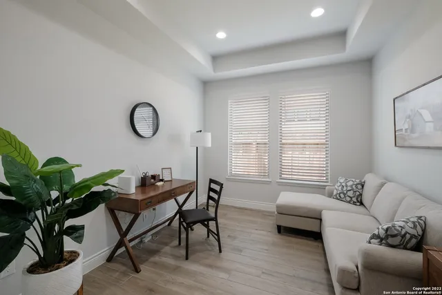 a living room with furniture a window and a potted plant