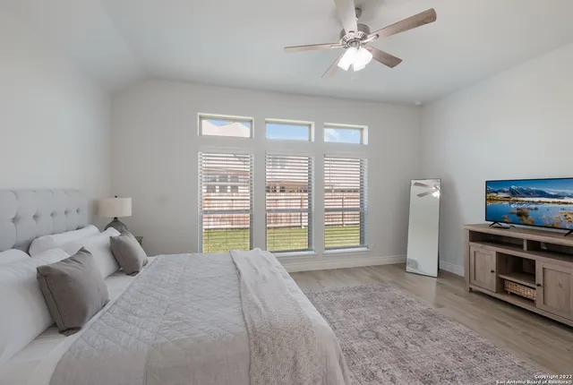 a bedroom with a bed and a television