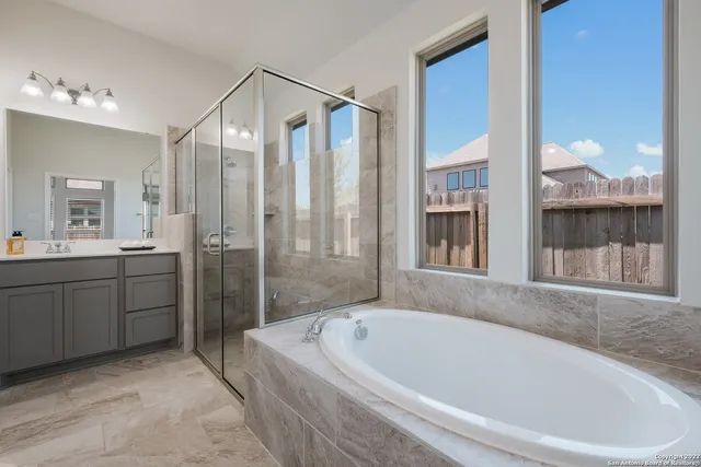 a white bath tub sitting next to a bathroom