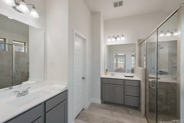 a bathroom with a granite countertop sink mirror and double