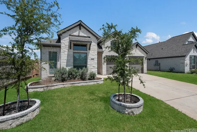 a front view of a house with a yard fire pit and entertaining space