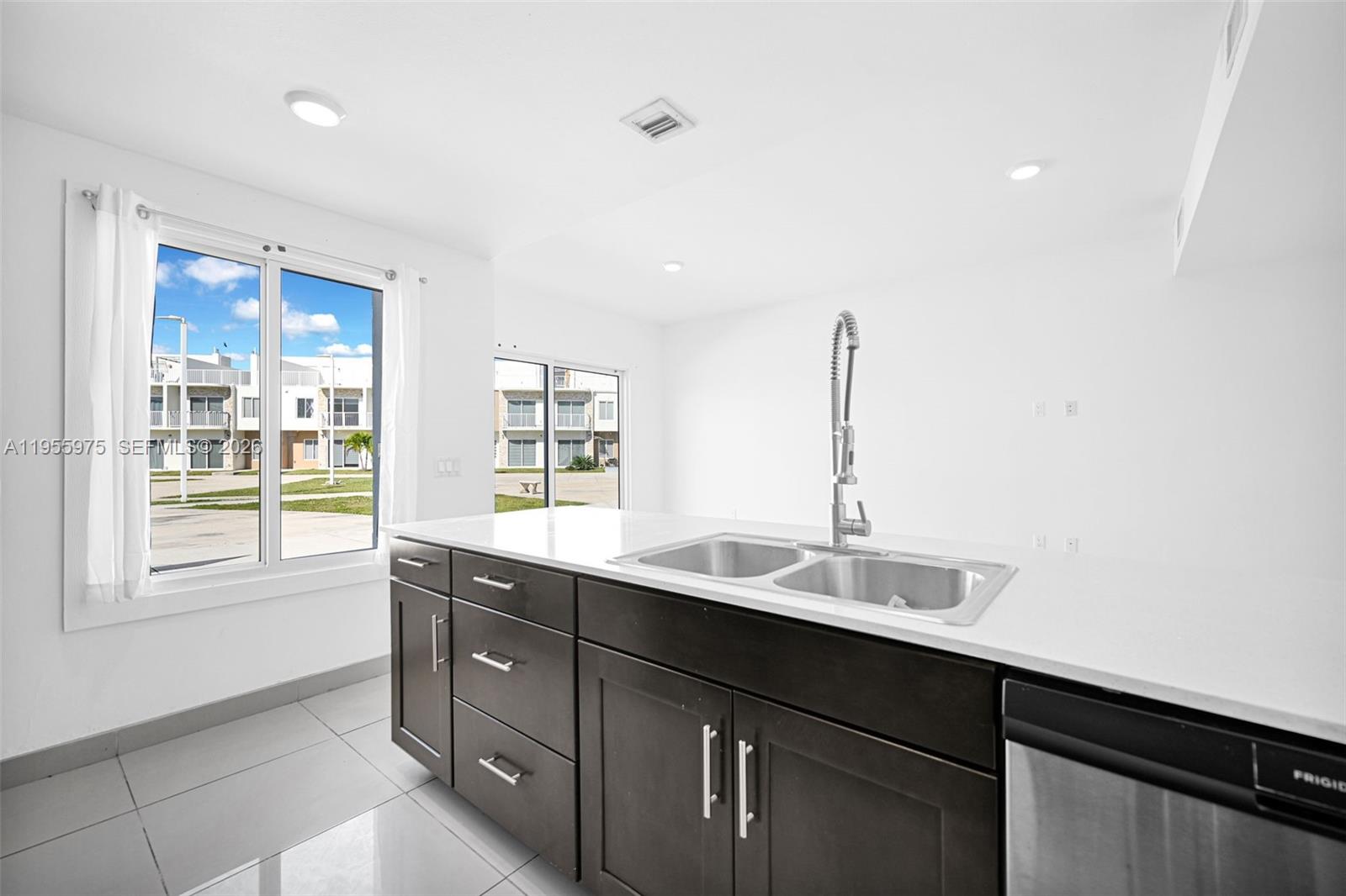 25874 Southwest 139th Court Homestead, FL 33033 - Photo 13 of 56 a kitchen with a sink and a window