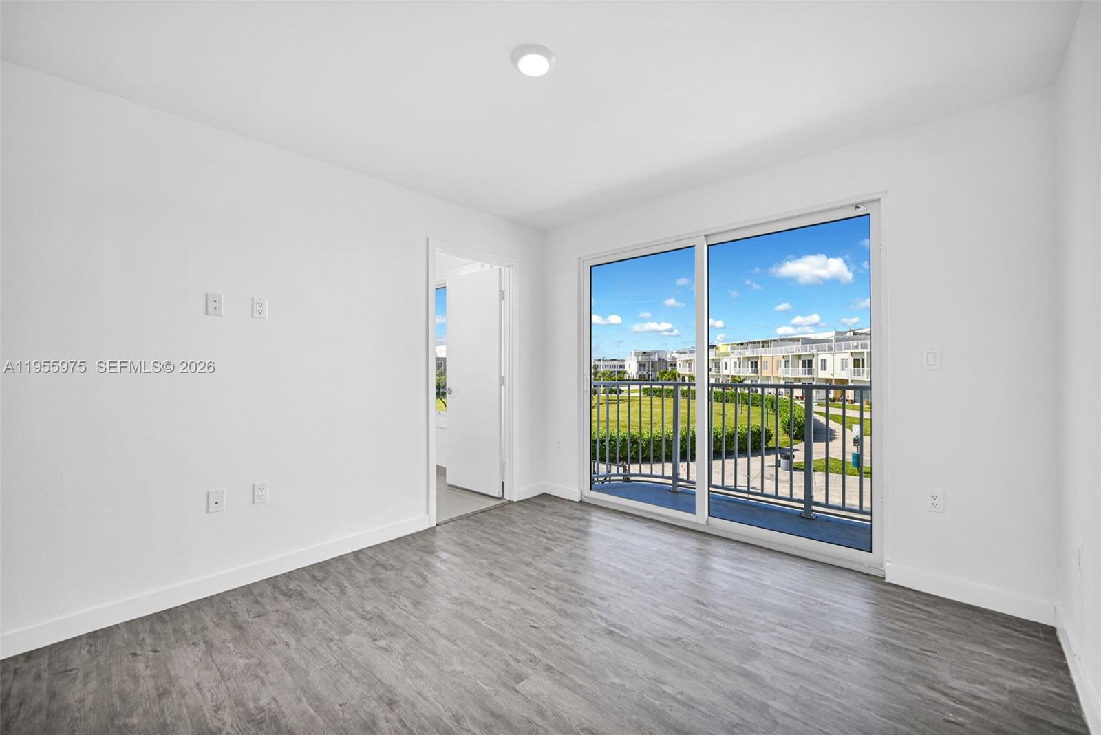 25874 Southwest 139th Court Homestead, FL 33033 - Photo 29 of 56 a view of a room with wooden floor and windows