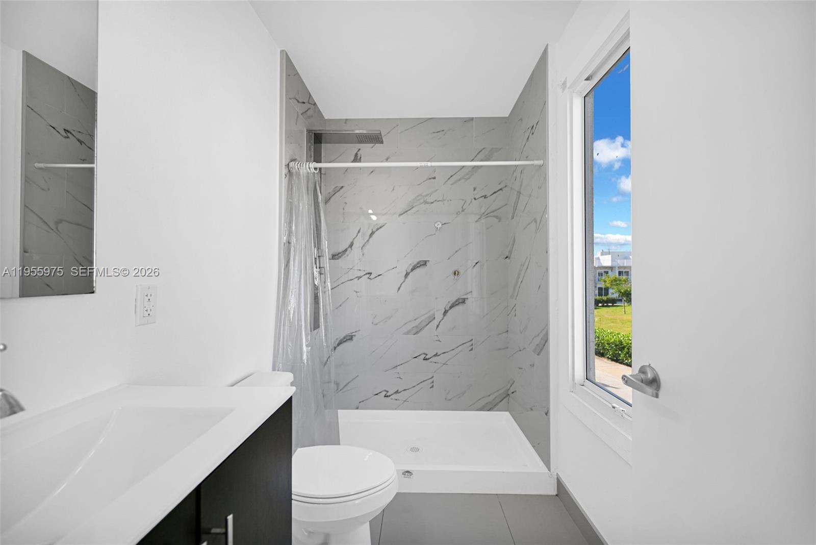 25874 Southwest 139th Court Homestead, FL 33033 - Photo 36 of 56 a bathroom with a bathtub shower sink vanity and toilet