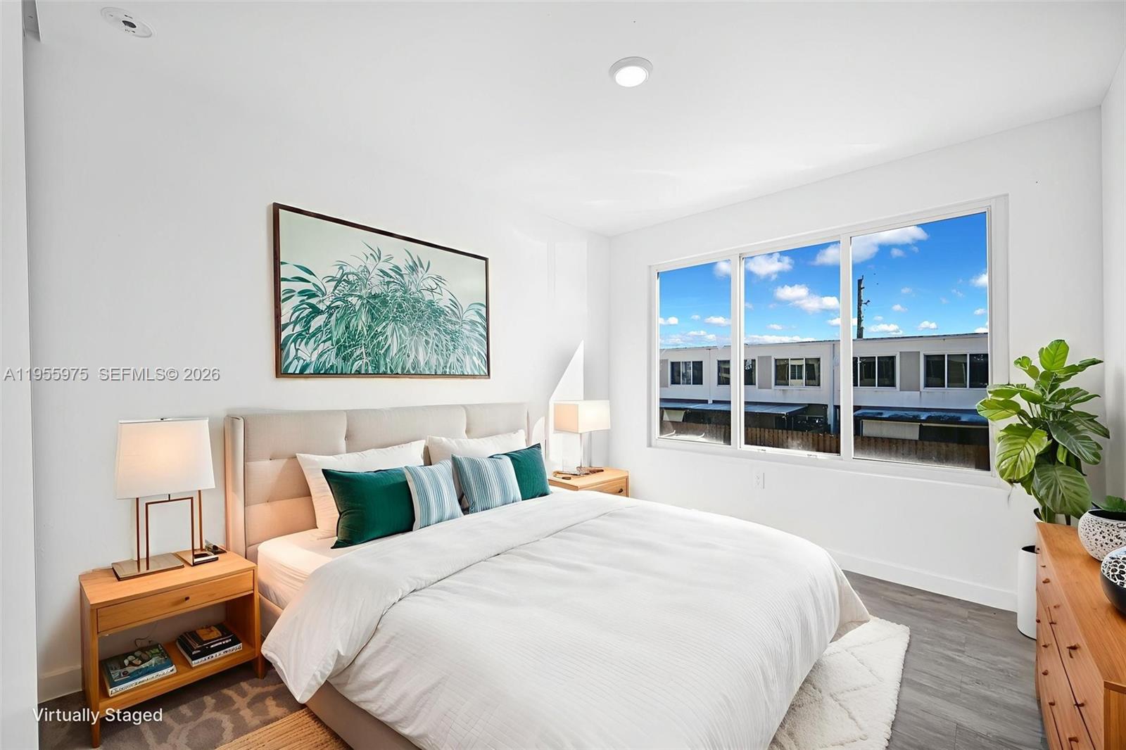 25874 Southwest 139th Court Homestead, FL 33033 - Photo 39 of 56 a bedroom with a large bed and a potted plant