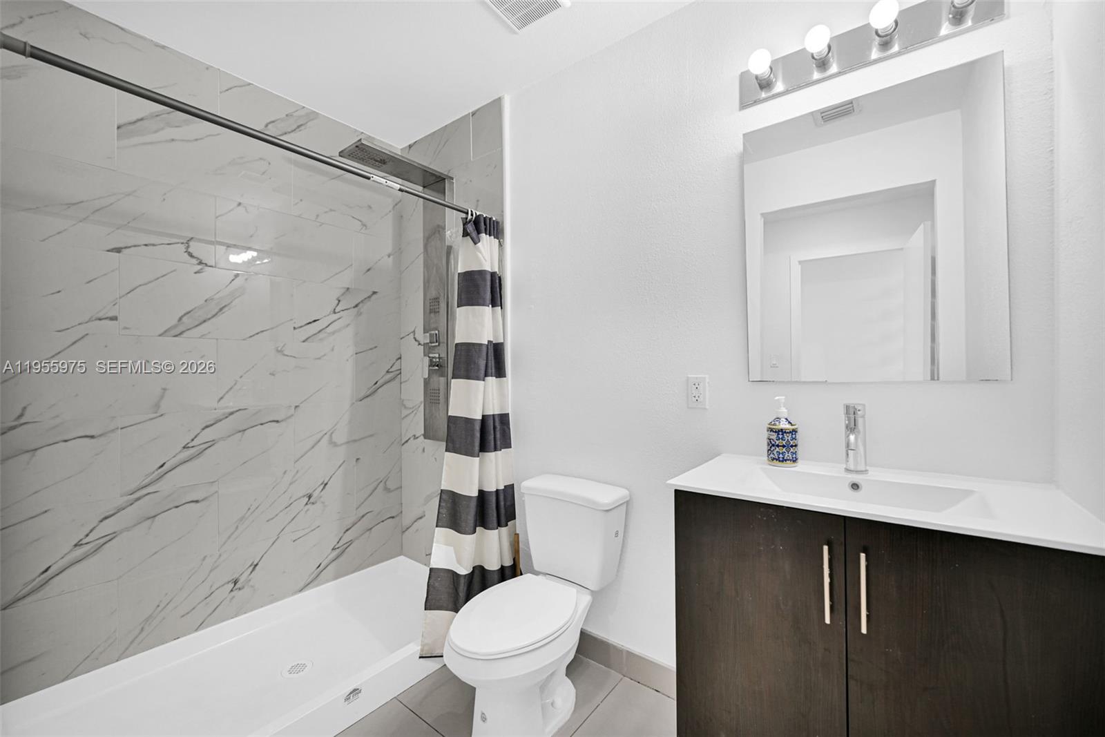 25874 Southwest 139th Court Homestead, FL 33033 - Photo 43 of 56 a bathroom with a sink toilet vanity and shower