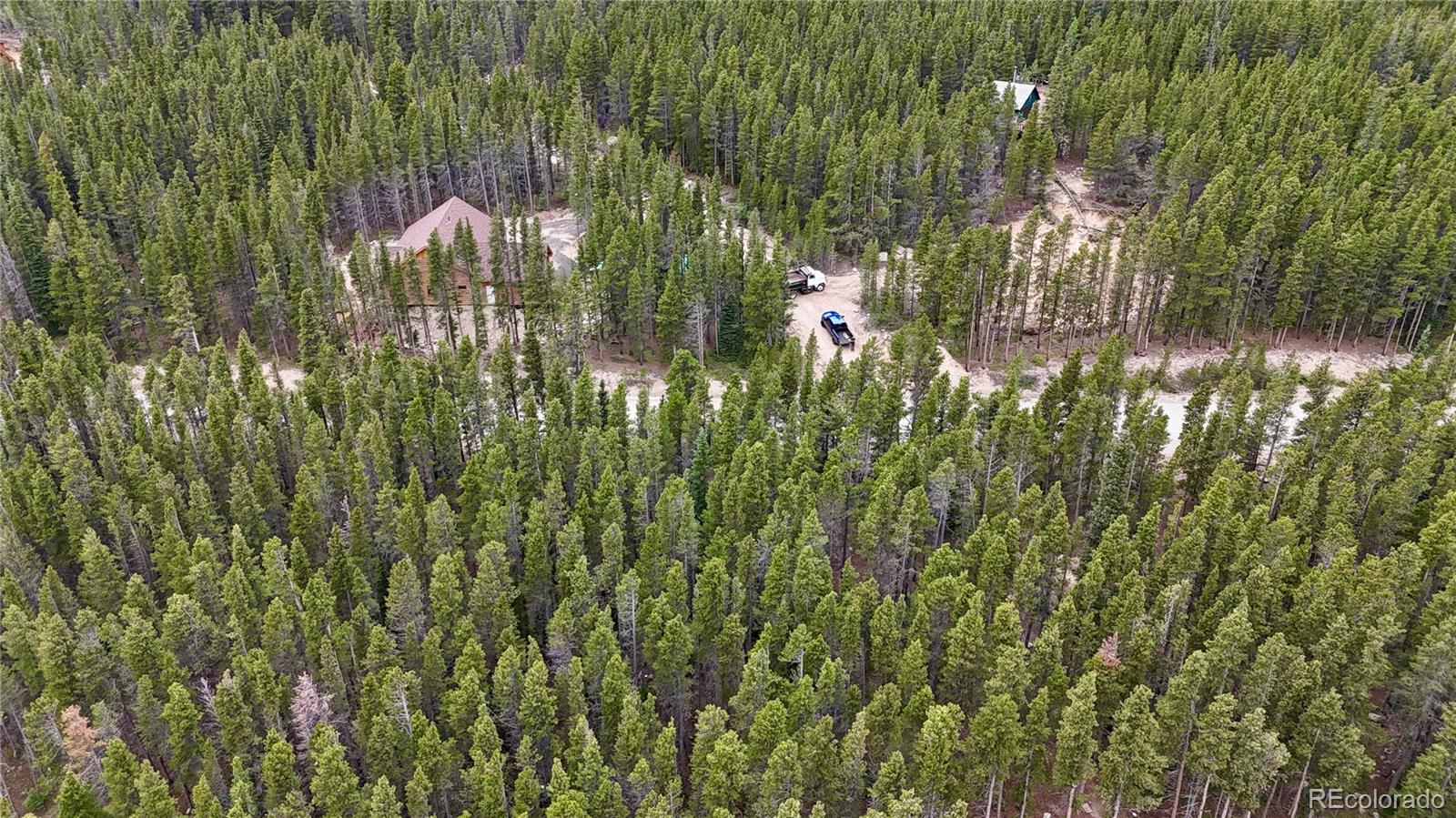 Lot 285 Lot Road Idaho Springs, CO 80452 - Photo 13 of 23 a backyard of a house with lots of green space and trees