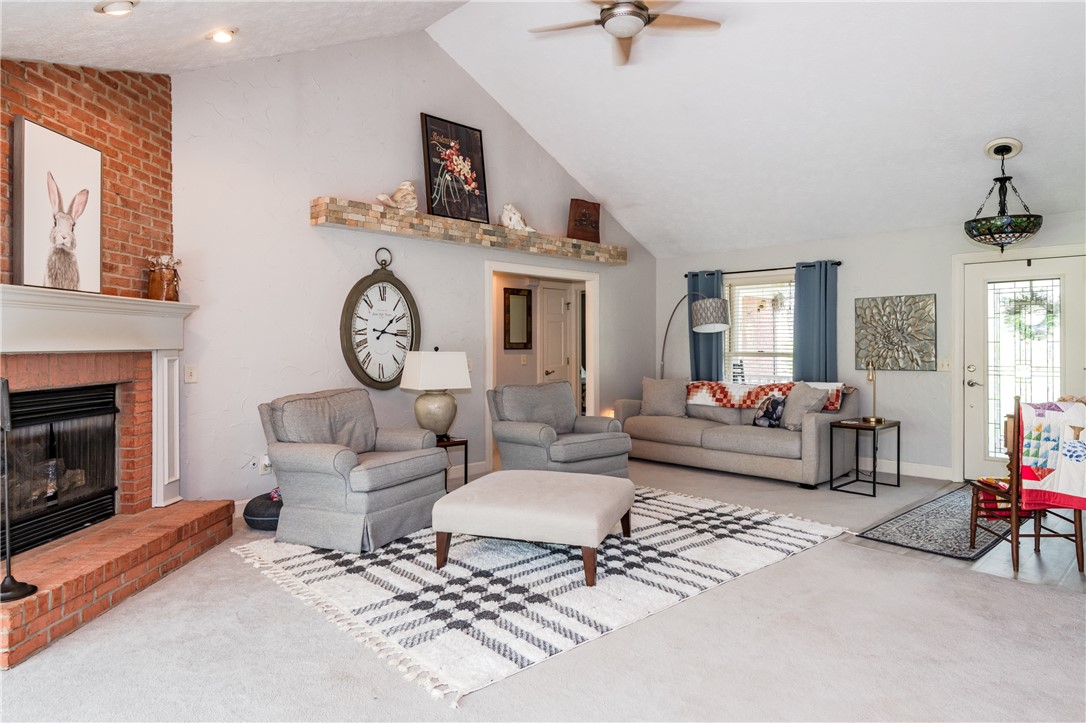 159 East Lytle 5 Points Road Springboro, OH 45066 - Photo 28 of 45 This inviting living space features vaulted ceilings and a classic brick fireplace, creating a warm ambiance.