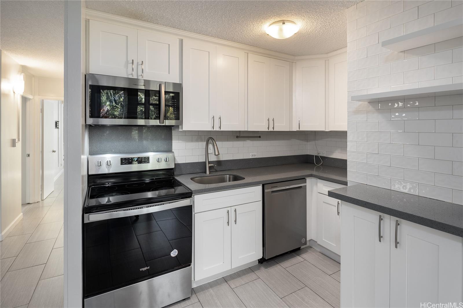 a kitchen with stainless steel appliances granite countertop a stove and a sink