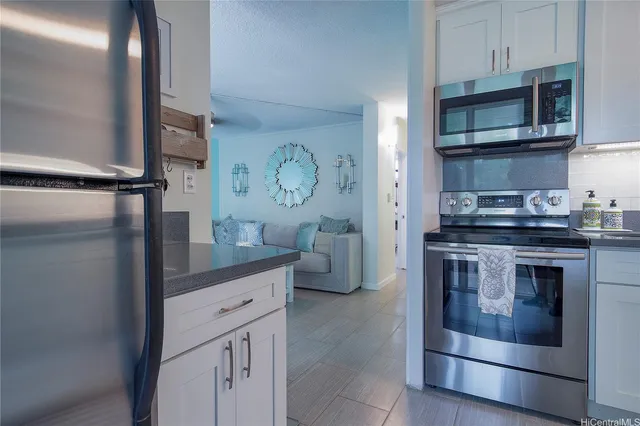 a kitchen with stainless steel appliances granite countertop a stove and a microwave